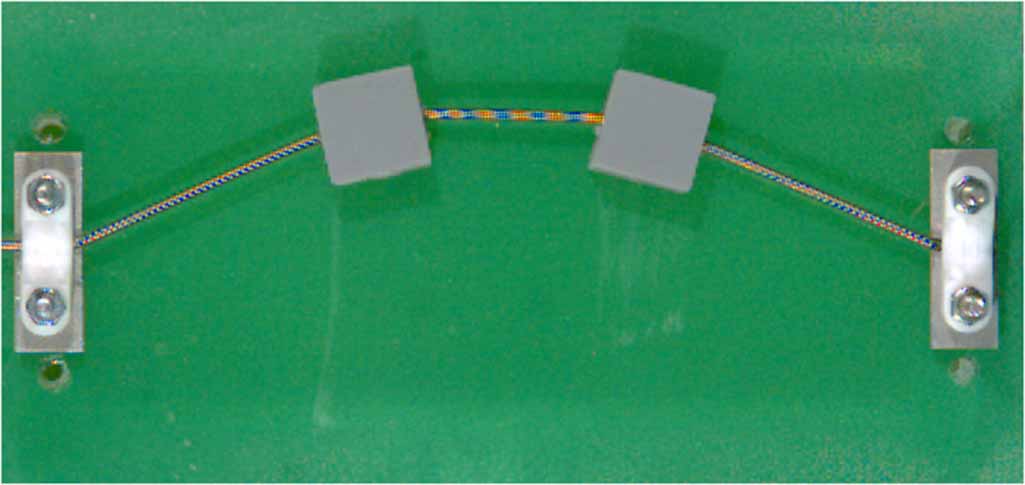 Nonlinear vibration of a loaded string in energy harvesting - IOPscience